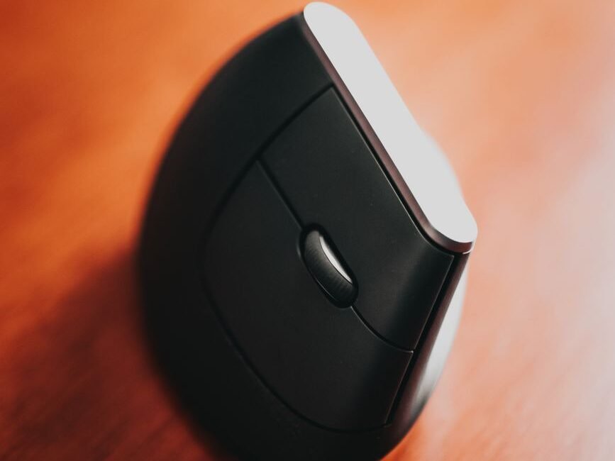 modern computer mouse on wooden table